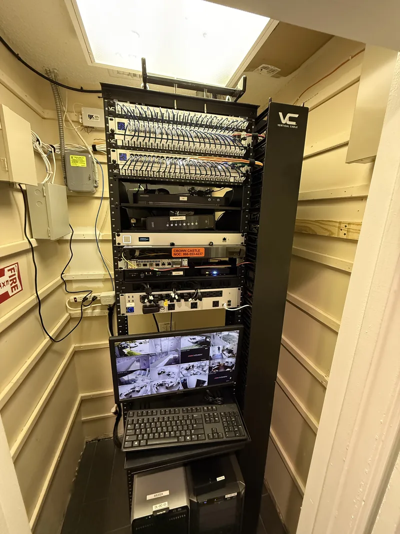 Organized network rack with patch panels and security monitoring equipment